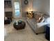 Bright living room with comfy sofa, coffee table, and tiled floors at 4301 Lizshire Ln # C-109, Orlando, FL 32822
