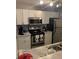 Modern kitchen with stainless steel appliances and white cabinets at 4301 Lizshire Ln # C-109, Orlando, FL 32822