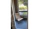 Relaxing screened patio with chair and small table at 4301 Lizshire Ln # C-109, Orlando, FL 32822