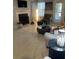 Living room features fireplace, large TV, and elegant tiled floors at 4301 Lizshire Ln # C-109, Orlando, FL 32822