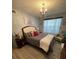 Bedroom with wood-look floors, comfortable bed, and relaxing atmosphere at 4301 Lizshire Ln # C-109, Orlando, FL 32822
