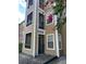 Tan 3-story building with balconies and lush landscaping at 4301 Lizshire Ln # C-109, Orlando, FL 32822