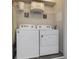 Laundry closet with washer, dryer, and shelving at 1505 Carey Palm Cir, Kissimmee, FL 34747