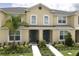 Two-story townhome with front yard landscaping at 1505 Carey Palm Cir, Kissimmee, FL 34747