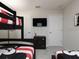 Bedroom with bunk beds, dresser, and TV at 1505 Carey Palm Cir, Kissimmee, FL 34747