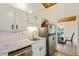Kitchen with white cabinets, stainless steel appliances, and marble countertops at 200 Maitland Ave # 2, Altamonte Springs, FL 32701