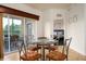 Bright dining area with glass table and four chairs, view to balcony and bedroom at 8763 Worldquest Blvd # 5406, Orlando, FL 32821