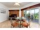 Small dining area with glass table and balcony access at 8763 Worldquest Blvd # 5406, Orlando, FL 32821
