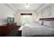 Spacious main bedroom with a king-size bed and large TV at 8763 Worldquest Blvd # 5406, Orlando, FL 32821