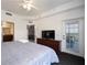Main bedroom with king bed, TV, and access to a private balcony at 8763 Worldquest Blvd # 5406, Orlando, FL 32821