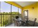 Screened balcony with table and chairs, wooded view at 8763 Worldquest Blvd # 5406, Orlando, FL 32821