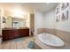 Bathroom with double vanity, soaking tub, and walk-in shower at 8763 Worldquest Blvd # 5406, Orlando, FL 32821