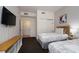 Bedroom with twin beds, TV, and access to bathroom at 8763 Worldquest Blvd # 5406, Orlando, FL 32821