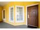 Bright condo entry with brown door and white-trimmed windows at 8763 Worldquest Blvd # 5406, Orlando, FL 32821