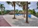 Beach area with lounge chairs, palm trees, and a wooden boardwalk at 315 Lucaya Loop # 315, Davenport, FL 33897