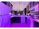 A kitchen with dark cabinets, white appliances, and purple lighting at 315 Lucaya Loop # 315, Davenport, FL 33897