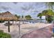 Relaxing sandy beach area with thatched umbrellas and lounge chairs near the lake at 315 Lucaya Loop # 315, Davenport, FL 33897