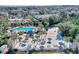 Aerial view of resort-style pool with sandy beach, volleyball court, and numerous palm trees at 315 Lucaya Loop # 315, Davenport, FL 33897