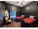 Bedroom with dark walls, two twin beds, and antique furniture at 315 Lucaya Loop # 315, Davenport, FL 33897