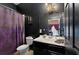 Dark-themed bathroom with purple shower curtain and vanity at 315 Lucaya Loop # 315, Davenport, FL 33897