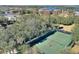 Aerial view of two tennis courts nestled within a tree-lined community setting at 315 Lucaya Loop # 315, Davenport, FL 33897