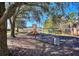 playground with swings, slides, and climbing structures under shade trees at 315 Lucaya Loop # 315, Davenport, FL 33897