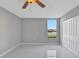 Bright bedroom with ceiling fan, tiled floors and a window with lake view at 540 Orange Dr # 13, Altamonte Springs, FL 32701