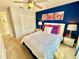 Bedroom with queen bed and blue and pink decor at 4805 Clock Tower Dr, Kissimmee, FL 34746