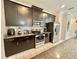 Modern kitchen with dark cabinets and granite counters at 4805 Clock Tower Dr, Kissimmee, FL 34746