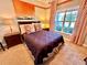 Bedroom with double bed and window overlooking the backyard at 4805 Clock Tower Dr, Kissimmee, FL 34746