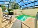 Private screened pool with lounge chairs at 4805 Clock Tower Dr, Kissimmee, FL 34746