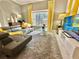 Living room with gray sectional and yellow accents at 4805 Clock Tower Dr, Kissimmee, FL 34746