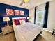 Bedroom with queen bed and blue and pink decor at 4805 Clock Tower Dr, Kissimmee, FL 34746