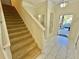 Bright entryway with staircase and view into the main living space at 4805 Clock Tower Dr, Kissimmee, FL 34746