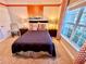 Bedroom with double bed and window overlooking the backyard at 4805 Clock Tower Dr, Kissimmee, FL 34746
