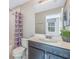 Bathroom with tub, toilet and dark brown vanity at 1509 Carey Palm Cir, Kissimmee, FL 34747