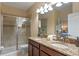 Double vanity bathroom with granite countertop and walk-in shower at 1424 Rolling Fairway Dr, Davenport, FL 33896