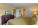 King-size bedroom with dresser and access to bathroom at 1424 Rolling Fairway Dr, Davenport, FL 33896