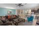 Open living room with sectional sofa, coffee table, and view of kitchen at 1424 Rolling Fairway Dr, Davenport, FL 33896
