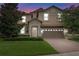 Two-story house with a tan exterior, brown garage door, and manicured lawn at 1424 Rolling Fairway Dr, Davenport, FL 33896