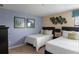 Bedroom with two twin beds, nightstands, and artwork at 1424 Rolling Fairway Dr, Davenport, FL 33896