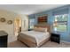 King-size bed in a spacious bedroom with an accent wall at 1424 Rolling Fairway Dr, Davenport, FL 33896