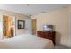 King-size bed in a spacious bedroom with ensuite bathroom and hallway access at 1424 Rolling Fairway Dr, Davenport, FL 33896