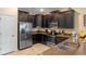 Modern kitchen with stainless steel appliances and dark wood cabinets at 1424 Rolling Fairway Dr, Davenport, FL 33896