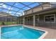 Inviting swimming pool with a screened enclosure at 1424 Rolling Fairway Dr, Davenport, FL 33896