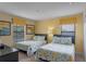 Two twin beds in a bright bedroom with yellow and floral bedding at 1424 Rolling Fairway Dr, Davenport, FL 33896