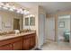 Double vanity bathroom with granite countertop and access to other rooms at 1424 Rolling Fairway Dr, Davenport, FL 33896