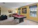 Game room features a pool table, comfortable seating, and a large TV at 1424 Rolling Fairway Dr, Davenport, FL 33896
