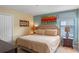 King-size bed in a tranquil bedroom with neutral tones and artwork at 1424 Rolling Fairway Dr, Davenport, FL 33896