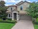 Two-story house with a large yard and brick driveway at 1424 Rolling Fairway Dr, Davenport, FL 33896